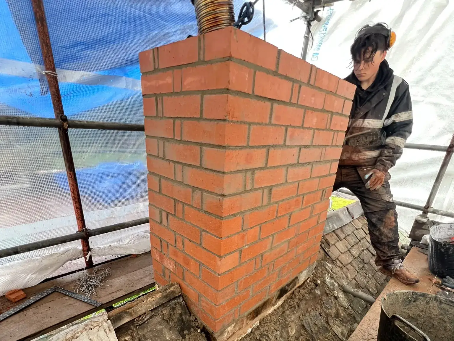 Chimney stack being rebuilt in new brick by AGM Roofing