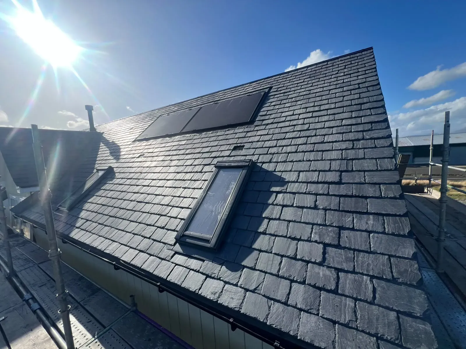 Finished natural slate roof with fitted roof windows and solar panels
