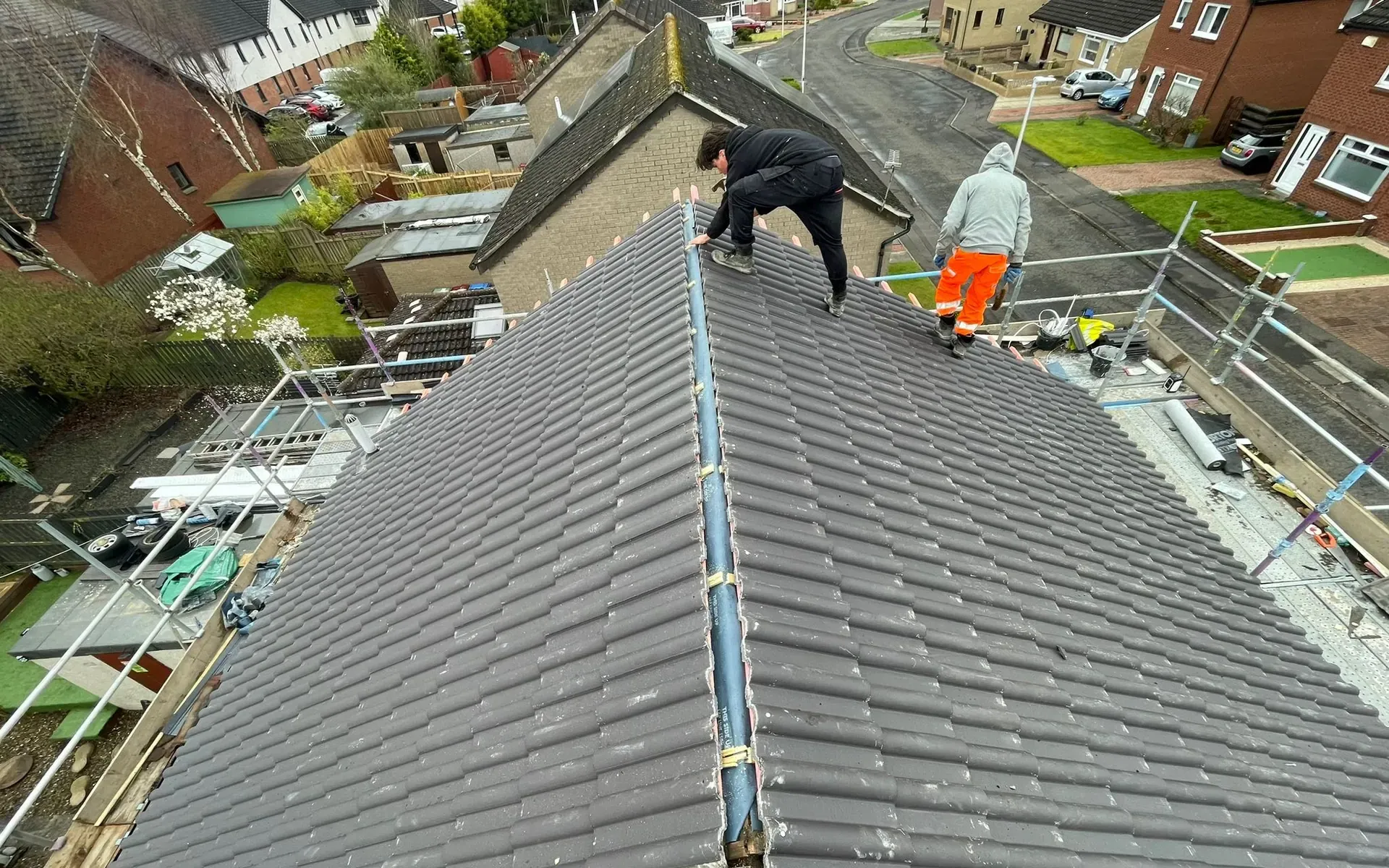 AGM Roofing team fitting a new tiled roof on a property in Falkirk